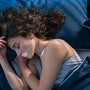 Woman sleeping with DreamTape mouth tape for nasal breathing