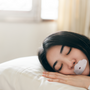 Woman sleeping peacefully - best sleeping position guide