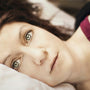 A person lying awake in bed unable to sleep