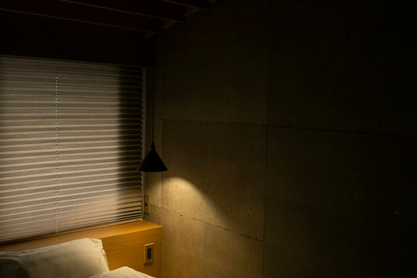 White bed linen with soft natural window light - peaceful bedroom