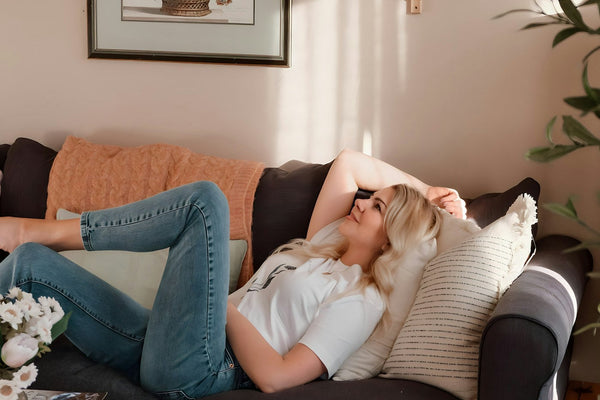A woman resting on a couch in a living room