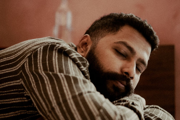 A man sleeping peacefully on his side in bed