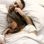 Couple resting together in bed in the morning light