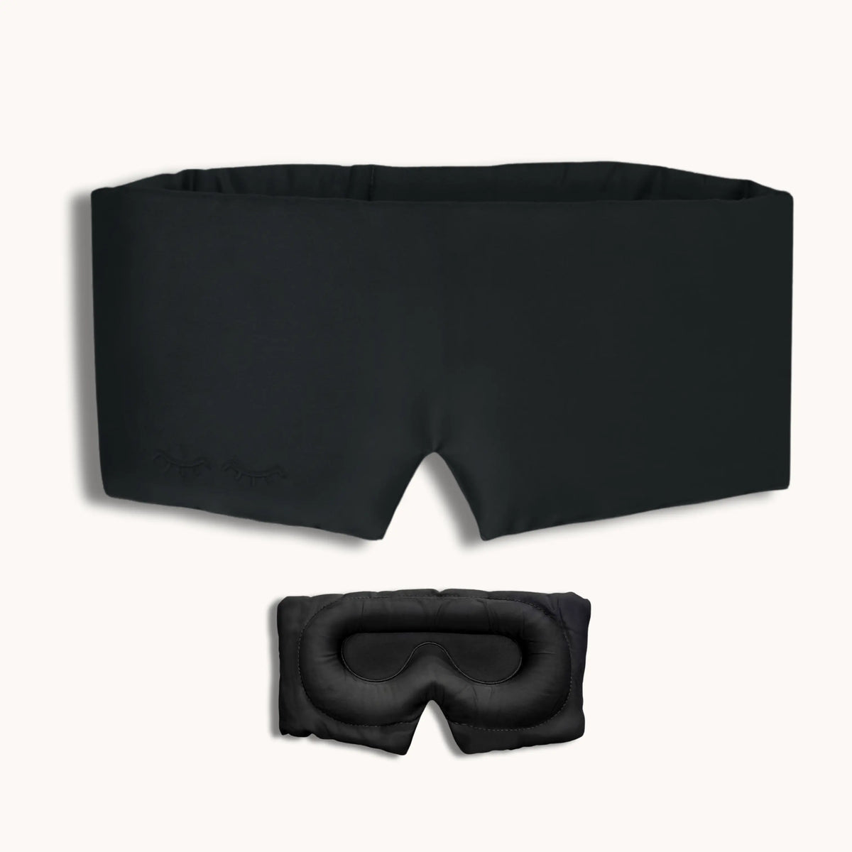 Black sleep mask and goggles on a white background