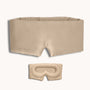 Beige sleep mask with strap on a white background